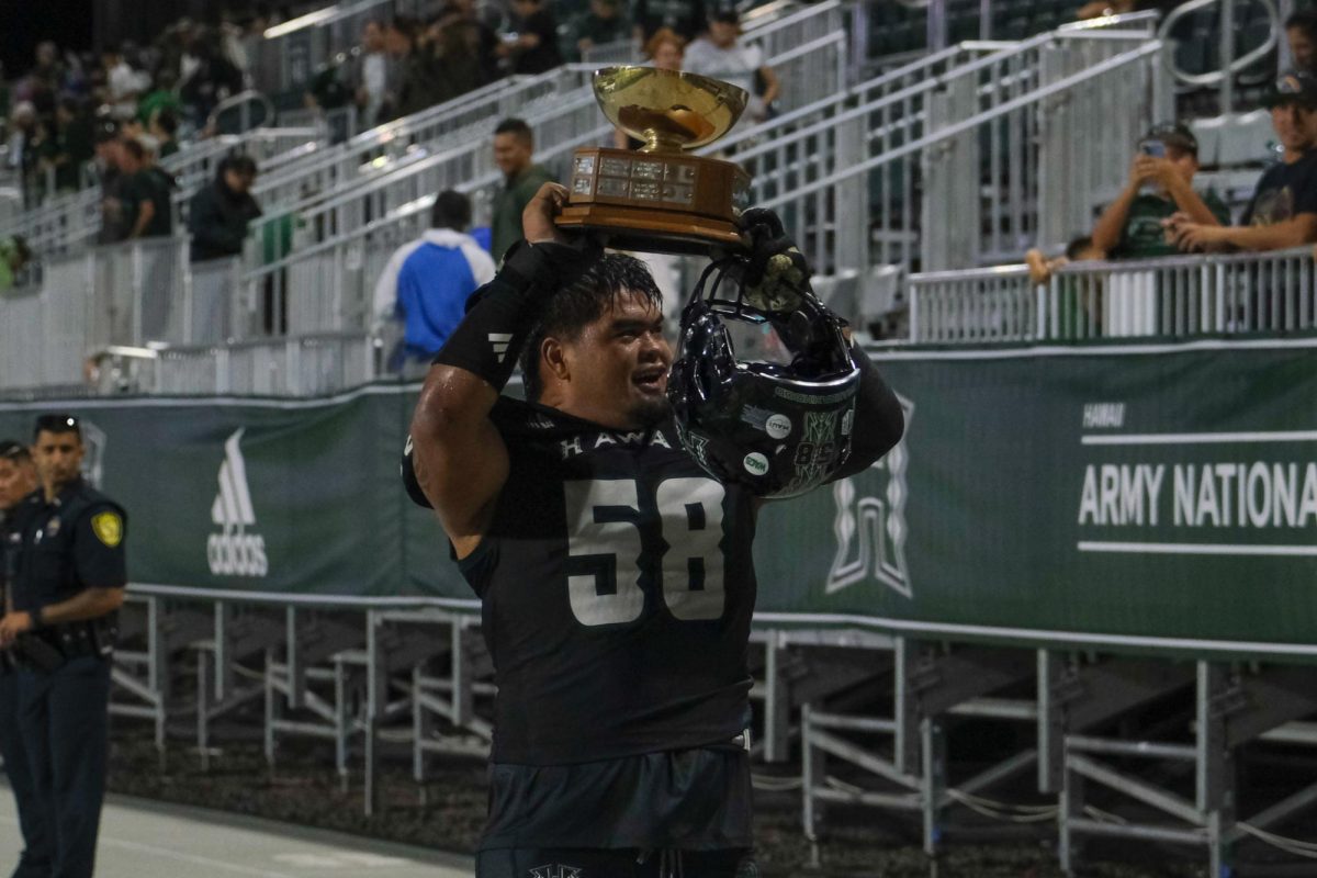 Kuao Peihopa holds tonights trophy high as the Warriors leave the field.