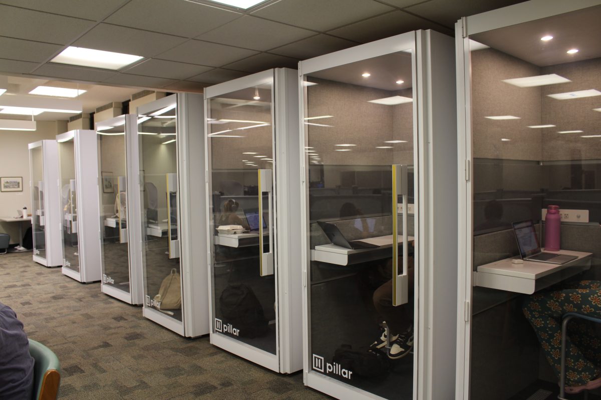 Seven of the 11 Pillar Booths located on the first floor of Hamilton Library, all occupied by students.