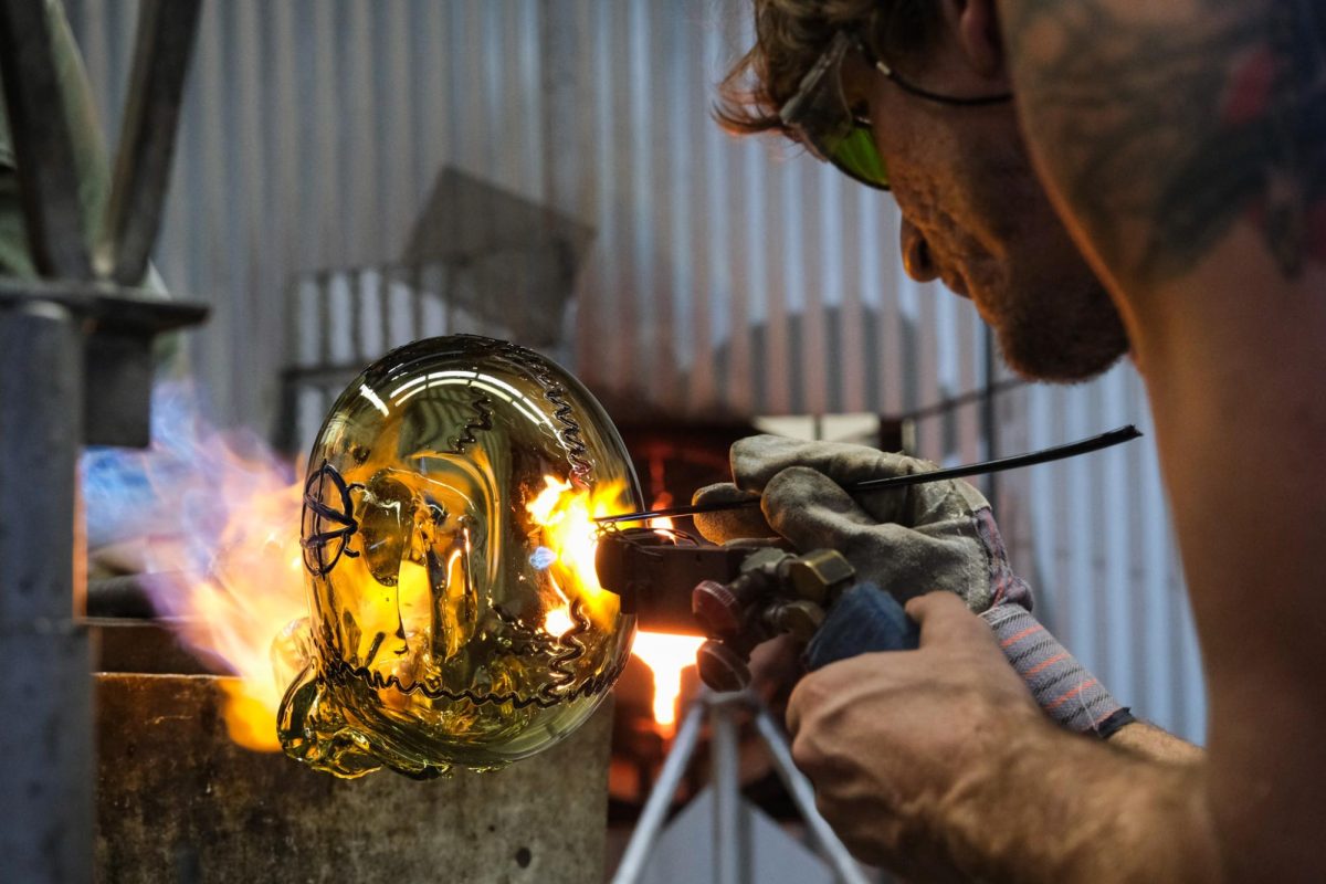 Schauss applied decorative markings to the skull using black glass rods as the glass skull neared completion. These rods were melted and applied to the piece directly while other students worked to ensure the piece didn't cool off too much.