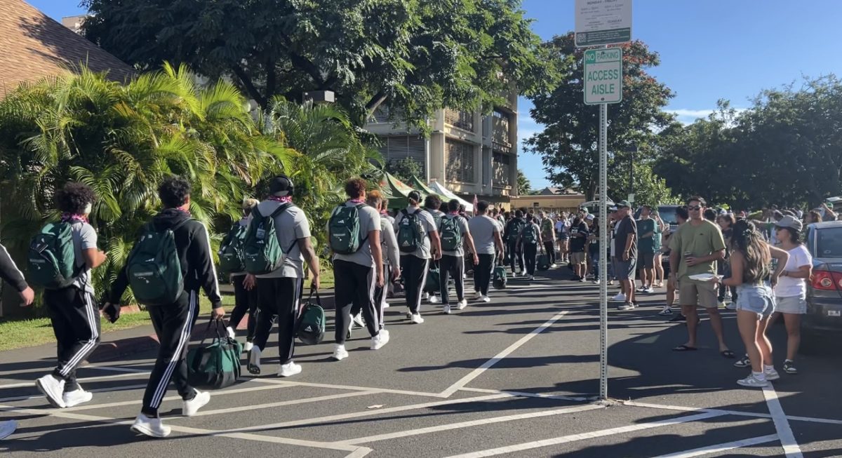 Excited fans cheer on the University of Hawaii’s football team as they make their appearance at the Tailgate debut