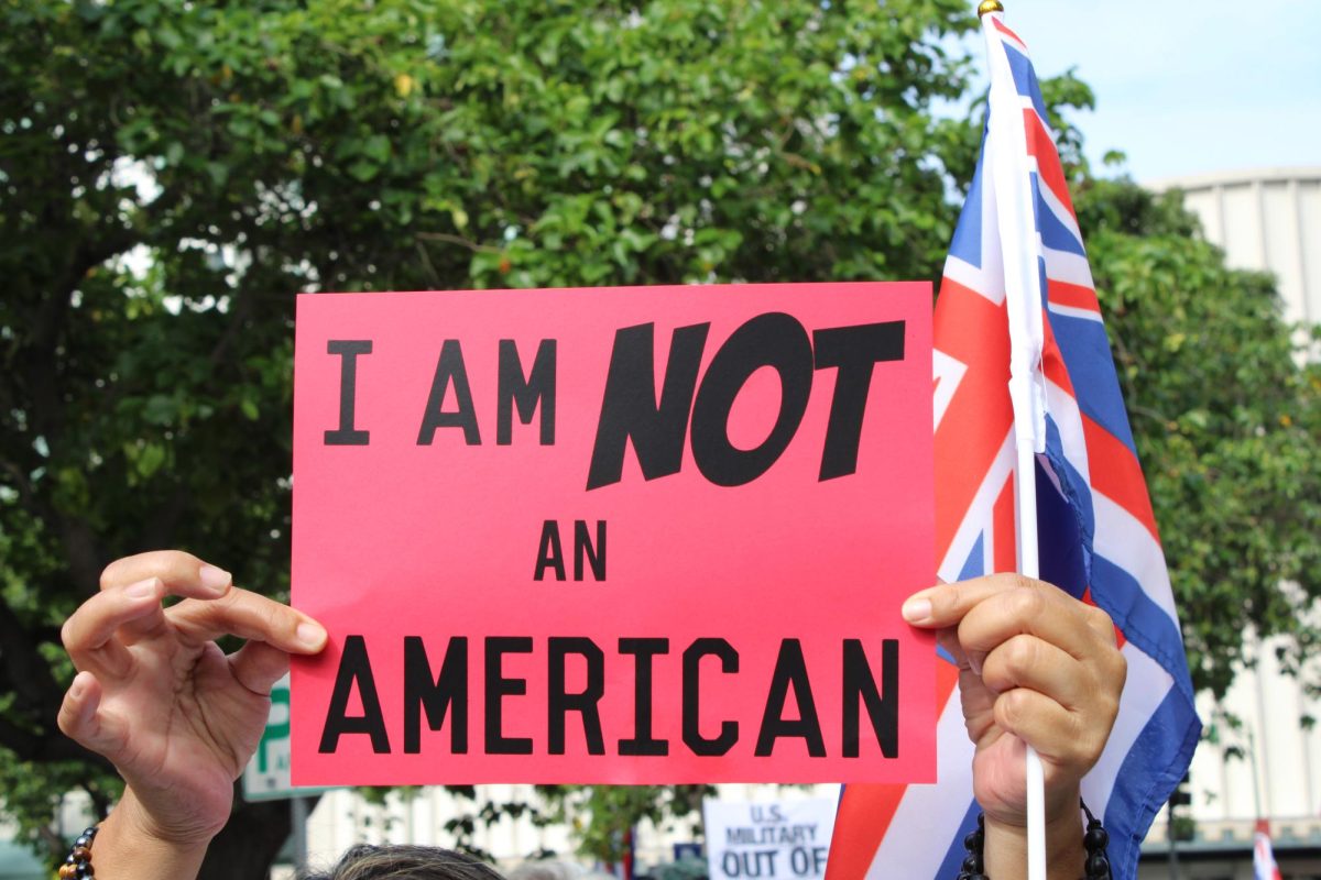 A member of the ʻOnipaʻa Peace March holds sign quoting the famous ʻOnipaʻa speech by kumu Haunani Kay Trask 32 years ago.