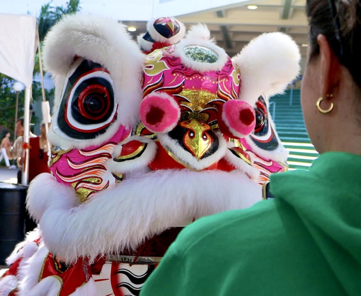 Participants in the event giving red envelopes to lion dancers.