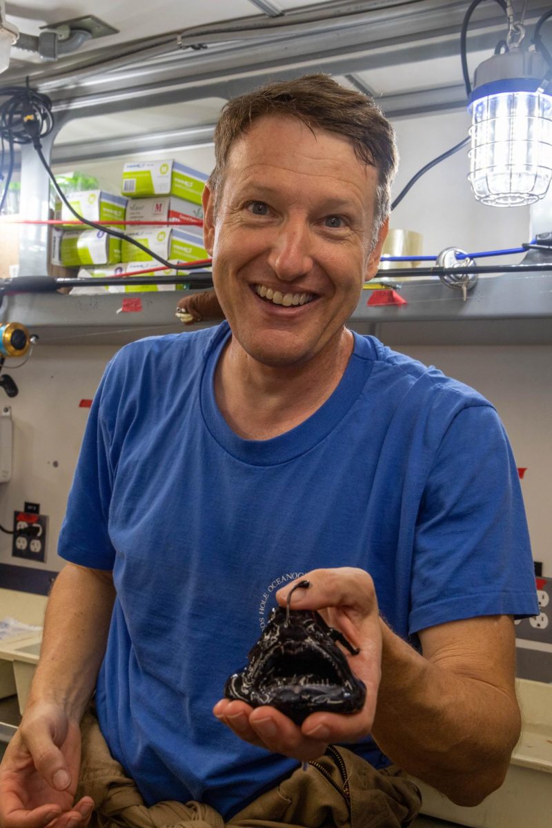 Dr. Jeff Drazen holding a deep-sea fish during a research expedition.