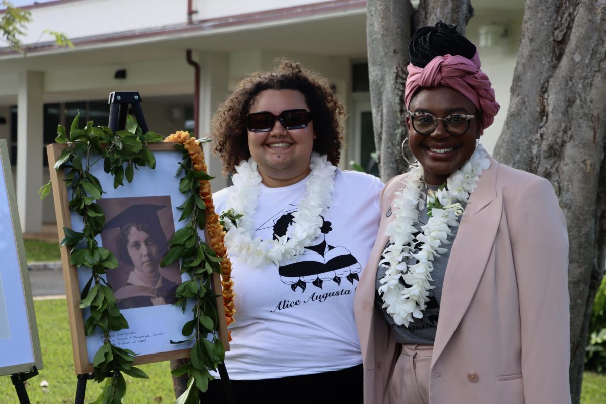 Niya Denise McAdoo(L) and LaJoya  Reed Shelly (R) stand next to a portrait of Alice Augusta Ball. 