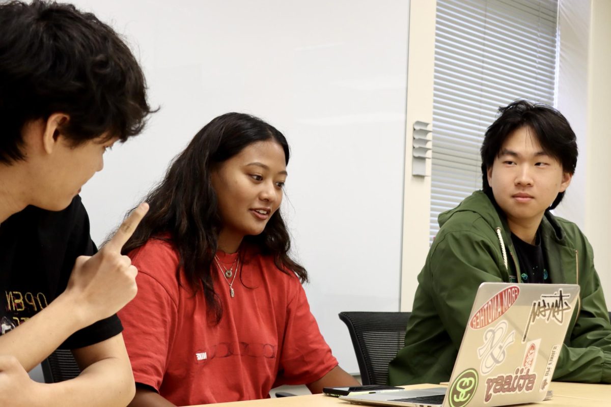 Students Christopher Kae, Reanna Ocampo and Brayden Kajiwara debate over the NFL draft.