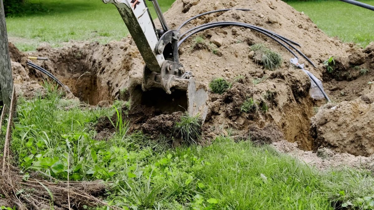 Construction equipment digging in the ground. 