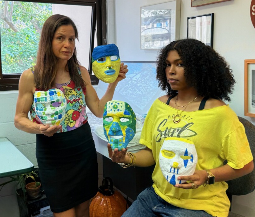 Yola Monakhov Stockton and her student Jasmine Jones display the masks made by the students.