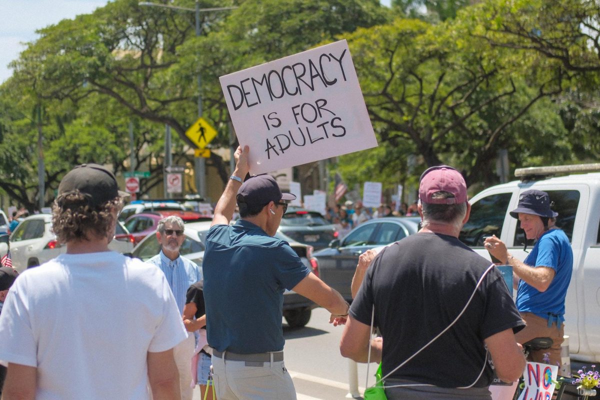 Demonstrators posed for a photo of their sign.