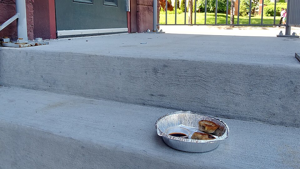 Uneaten food in a to-go container.